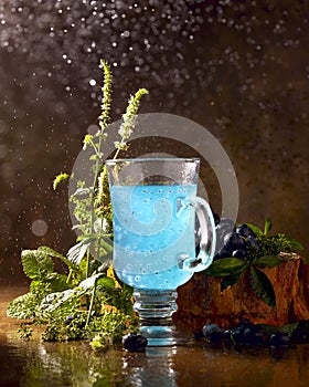 Refreshing blue drink with baslic grains and blooming fresh mint