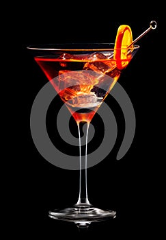 Refreshing Bourbon Manhattan cocktail with vermouth and maraschino cherry garnish isolated on black background/