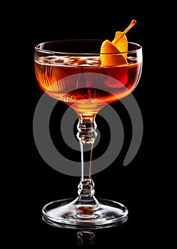 Refreshing Bourbon Manhattan cocktail with vermouth and maraschino cherry garnish isolated on black background/