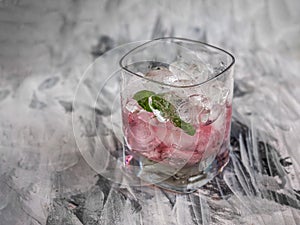 Refreshing cherry drink with ice in a glass glass