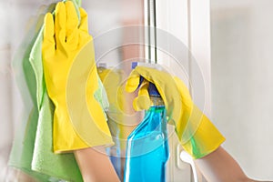 Refreshing Cleanliness: Female Hands Cleaning Windows at Home