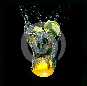 Refreshing cocktail in imaginary glass out of water splashes on black background