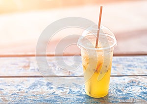 Refreshing cold drink with fresh lime, passionfruit and ice. On wooden planks. Background. Freshment. Summer.