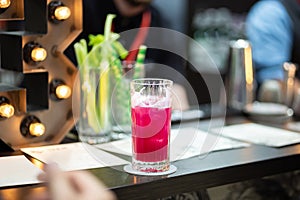 Refreshing cold pink cocktail in a tall glass