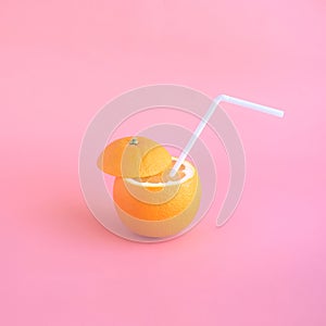 Refreshing concept with orange juice and straw in pastel color