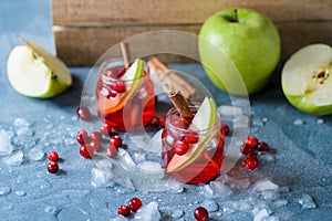 Refreshing cranberry drink with apples and ice