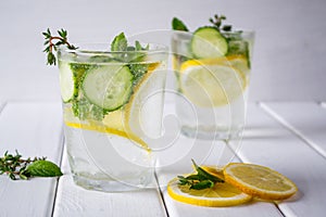 Refreshing cucumber cocktail, lemonade, detox water in a glasses on a white background.