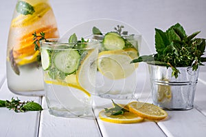 Refreshing cucumber cocktail, lemonade, detox water in a glasses on a white background.