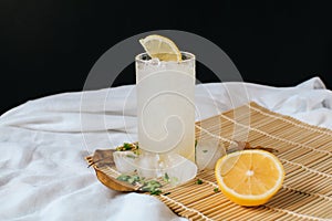 Refreshing drink or beverage homemade ice lemonade juice soda cocktail with fresh slice lemon and mint on white table