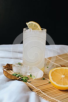 Refreshing drink or beverage homemade ice lemonade juice soda cocktail with fresh slice lemon and mint on white table