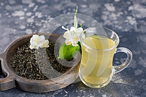Refreshing drink in a glass cup. Green tea with jasmine.