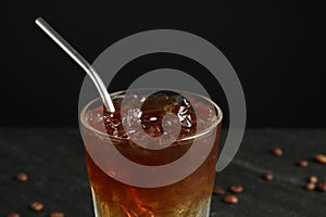 Refreshing espresso tonic drink on dark background, closeup