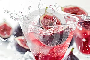 Refreshing Fig and Pomegranate Cocktail Splash on a Vibrant Background