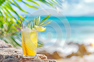 Refreshing fruit cocktail on a rocky seaside setting, garnished with a lemon wedge