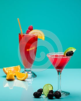 Refreshing fruit cocktails on pastel turquoise background