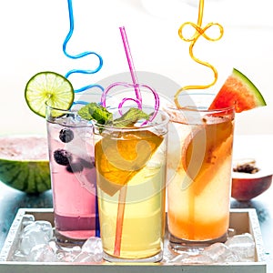 Refreshing fruit flavoured seltzer water with fruit garnish and crazy straws.