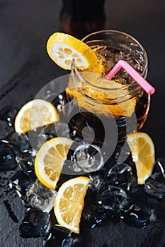 Refreshing glass of iced lemon tea with lemon slices, served over a bed of ice