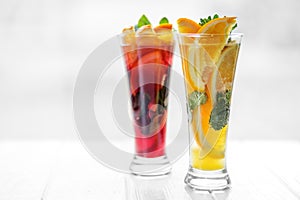 Refreshing healthy cocktails with mint and citrus and pomegranate on a white background. Concept for drinks, summer, heat, alcohol