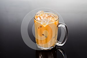 Refreshing ice cold coffee with milk in transparent glass