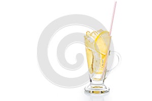 Refreshing ice cold ginger lemon tea in transparent glass