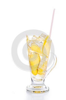 Refreshing ice cold ginger lemon tea in transparent glass on vertical orientation