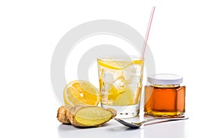 Refreshing ice cold honey ginger lemon tea in transparent glass