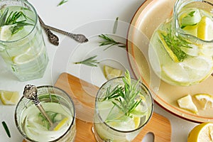 Refreshing iced drink with lemon and fresh rosemary