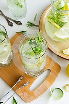 Refreshing iced drink with lemon and fresh rosemary