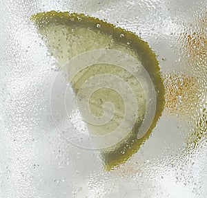 Refreshing lemon slice frozen in ice