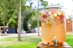 Refreshing lemonade with lime, strawberry and pineapple in glass jars with tap. Concept of drinks, summer, bar, rest