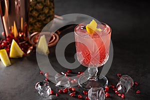 Refreshing and light pomegranate and pineapple summer cocktail with ice cubes