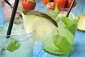 Refreshing melon mojito on a rustic blue table