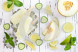 Refreshing mexican style ice pops - cucumber, lime, honeydew margarita paletas - popsicles. Top view. Cinco de Mayo recipe