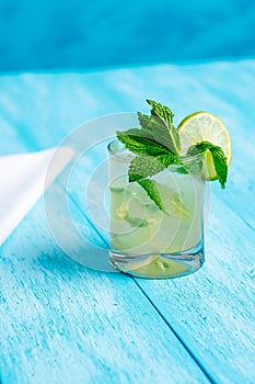 Refreshing Mojito Cocktail on a bright blue background