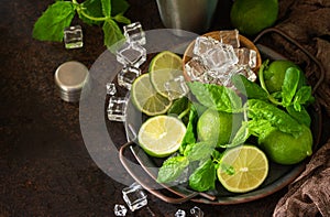 Refreshing Mojito cocktail making. Mint, lime, ice ingredients and bar utensils