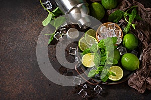 Refreshing Mojito cocktail making. Mint, lime, ice ingredients and bar utensils