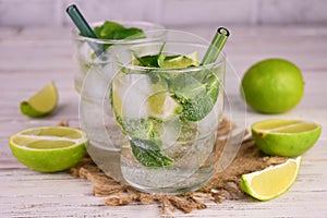 Refreshing mojito withs lime and mint on a white background.