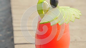 Refreshing orange cocktail on beach table.
