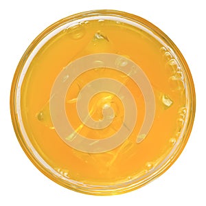 refreshing orange drink with ice in a glass, top view,