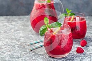 Refreshing raspberry, lemon and mint lemonade with sparkling water in  a glass, horizontal, copy space