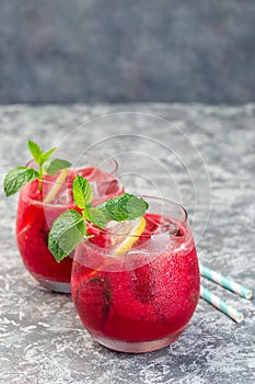 Refreshing raspberry, lemon and mint lemonade with sparkling water in  glass, vertical, copy space