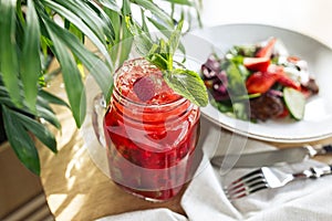 Refreshing red cocktail with strawberries