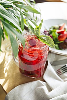 Refreshing red cocktail with strawberries