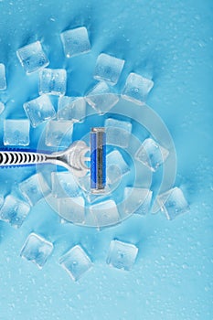 Refreshing shaving machine on the background of frosty ice cubes without irritation