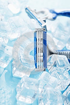 Refreshing shaving machine on the background of frosty ice cubes without irritation