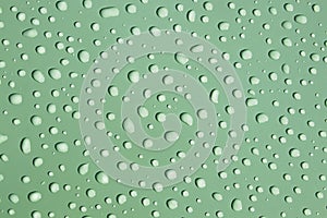 Refreshing sherbert green background - water drops on textured green surface photo