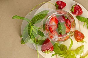 Refreshing strawberry water or lemonade decorated with mint leaves