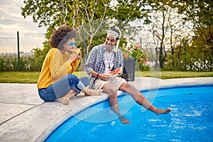 Refreshing Summer Bites: A Couple Indulging in Watermelon Delights by the Poolside