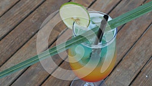 Refreshing summer cocktail on beach table.