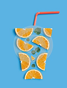 Refreshing summer cocktail concept. Creative flat lay arrangement of orange slices, fresh mint leaves and drinking straw in the